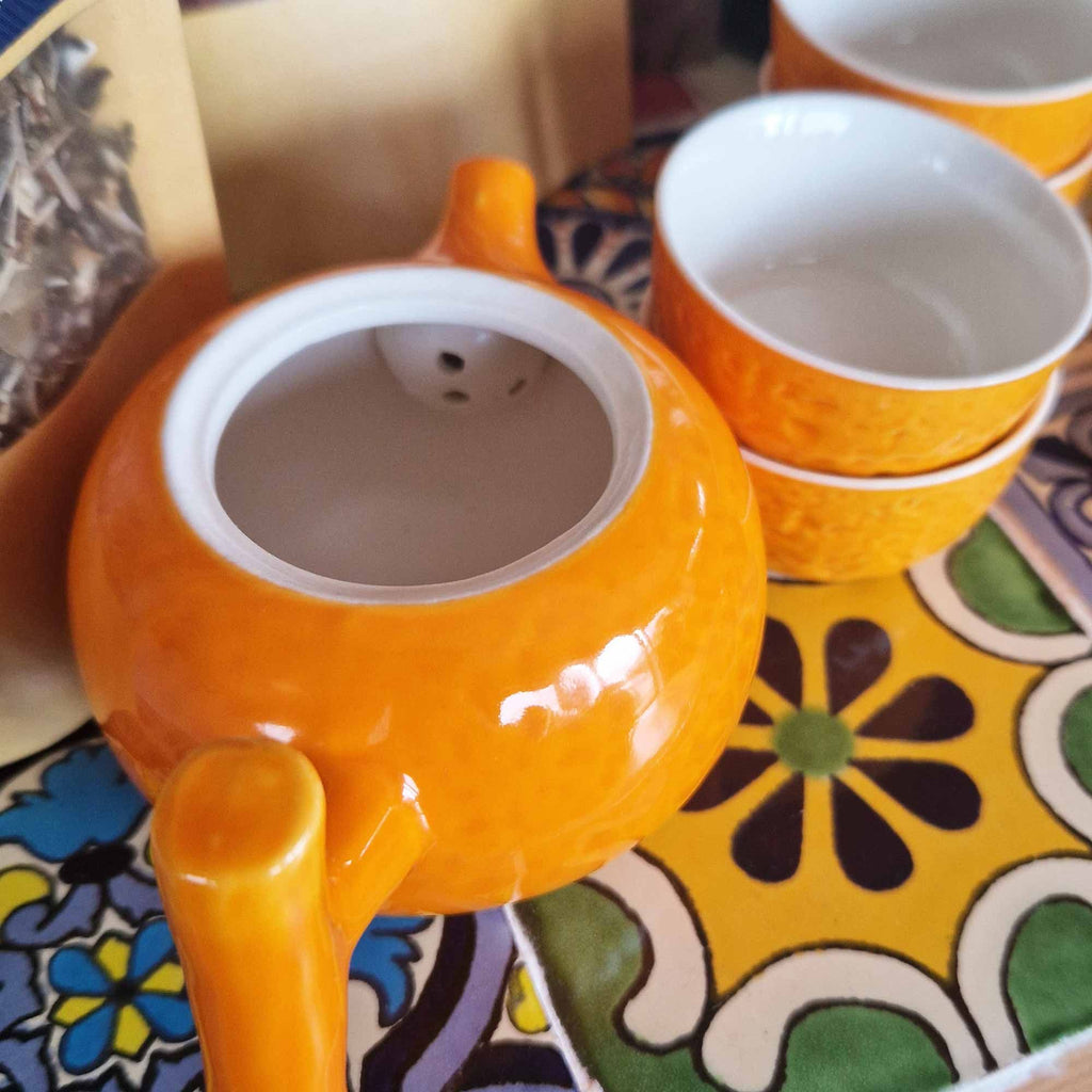 Herbal Orange Teapot Set with Four Matching Cups for Tea Lovers