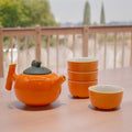 Herbal Orange Teapot Set with Four Matching Cups for Tea Lovers