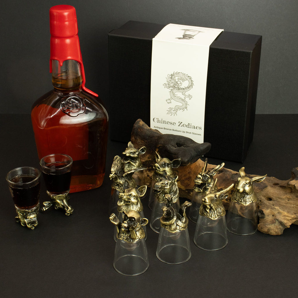 Bottle of Johnnie Walker Red Label whisky with decorative glasses and a box on a dark surface