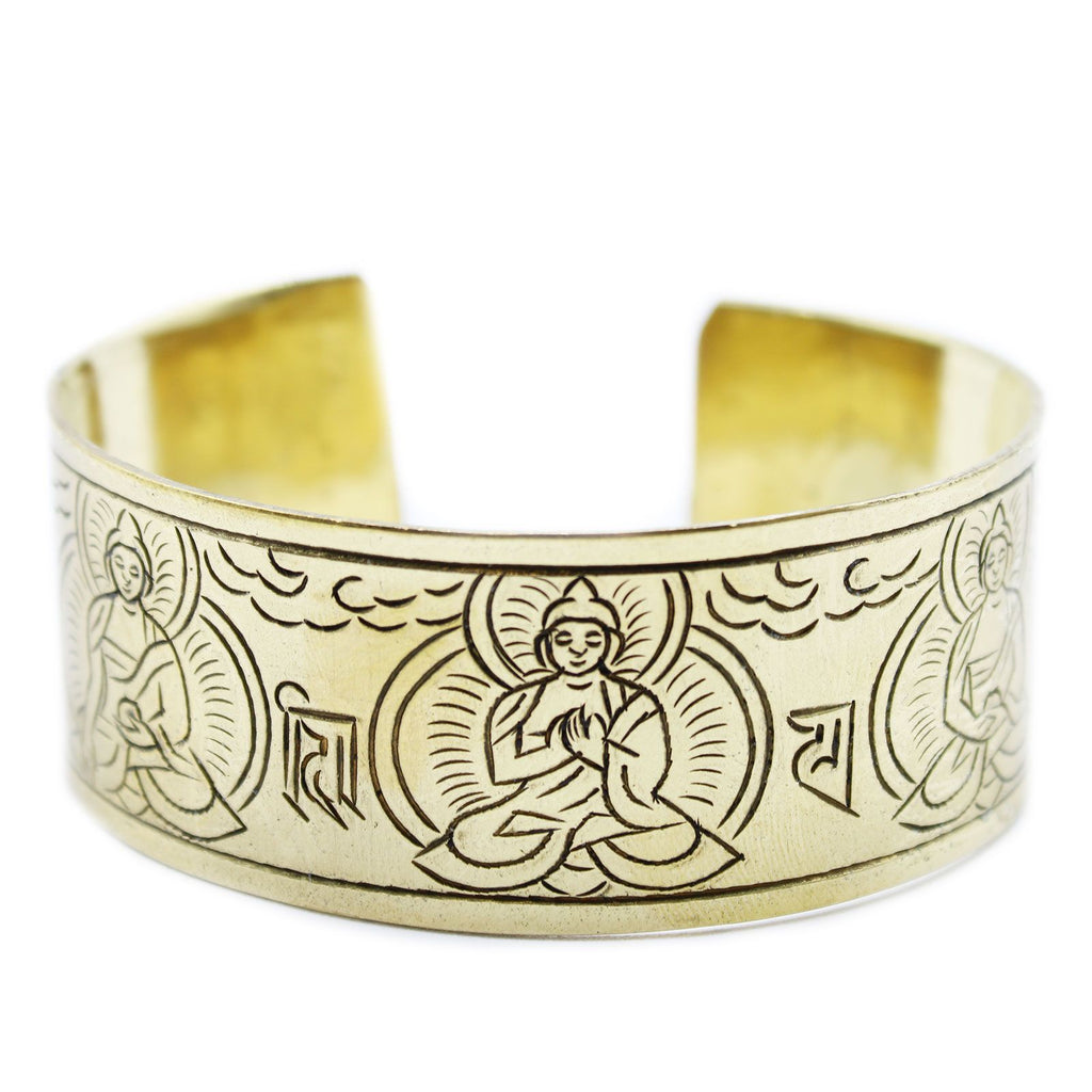 Gold bracelet with engraved designs on a white background